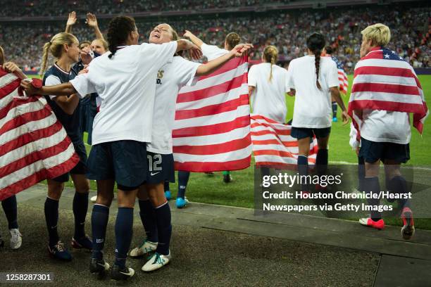 United States' Lauren Cheney gets a hug from Shannon Boxx as they celebrate their win over Japan in the women's soccer gold medal match at the 2012...