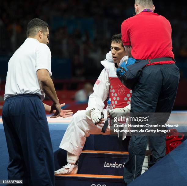 Steven Lopez of the USA gets direction from his coach Jean Lopez before the final round of his bout against Azerbaijan's Ramin Azizov in the men's...