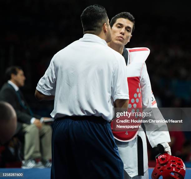 Steven Lopez of the USA gets a kiss from his coach, and brother, Jean Lopez before fighting Azerbaijan's Ramin Azizov in the men's 80-kg taekwondo...