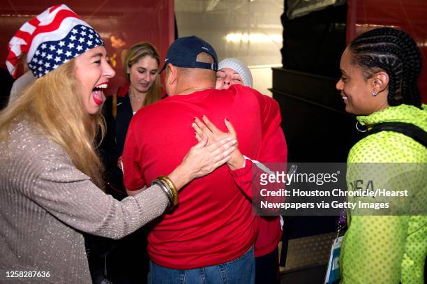Marlen Esparza hugs her father Daniel Esparza as family friend Sofia Adroque, left, and US boxer Queen Underwood, right, look on after Esparza's loss...