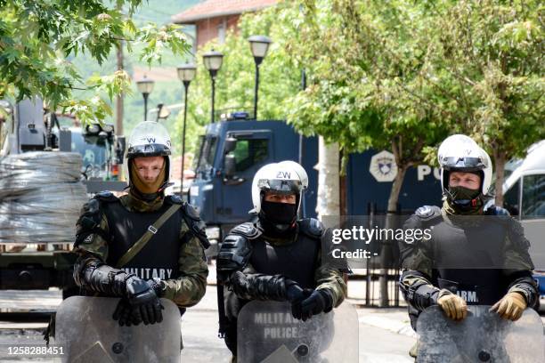 The NATO soldiers wearing full riot gear are standing in front of the municipal building in Zvecan, northern Kosovo on May 30 a day following clashes...