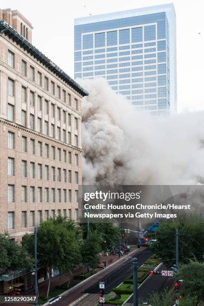 Series of explosive charges brings down the landmark former Macy's department store building in downtown Houston on Sunday, Sept. 22, 2013. Many...