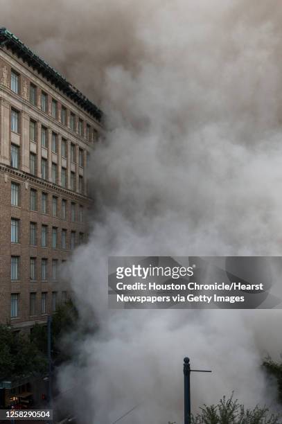 Series of explosive charges brings down the landmark former Macy's department store building in downtown Houston on Sunday, Sept. 22, 2013. Many...