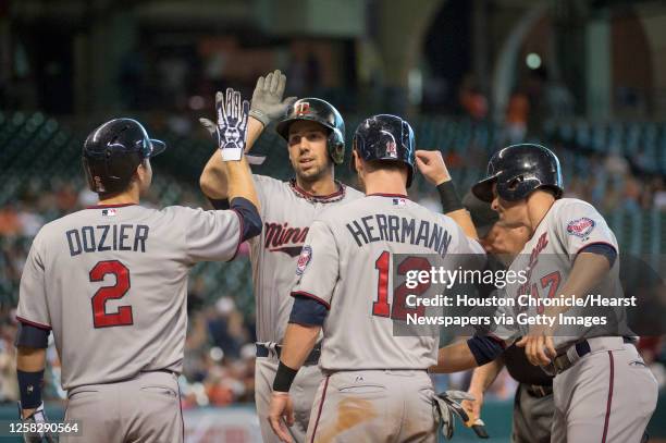 Minnesota Twins first baseman Chris Colabello is greeted at home by Brian Dozier , Chris Herrmann and Doug Bernier after they all scored on his grand...