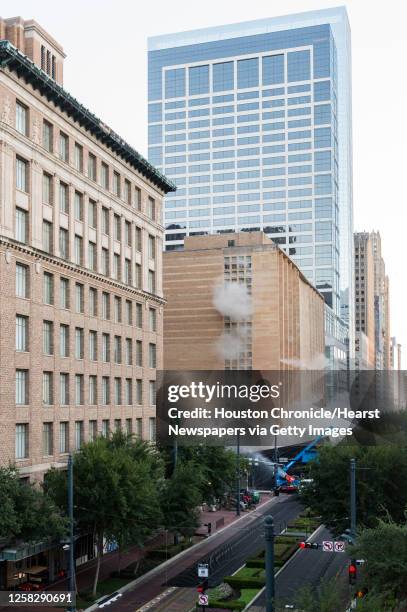 Series of explosive charges brings down the landmark former Macy's department store building in downtown Houston on Sunday, Sept. 22, 2013. Many...