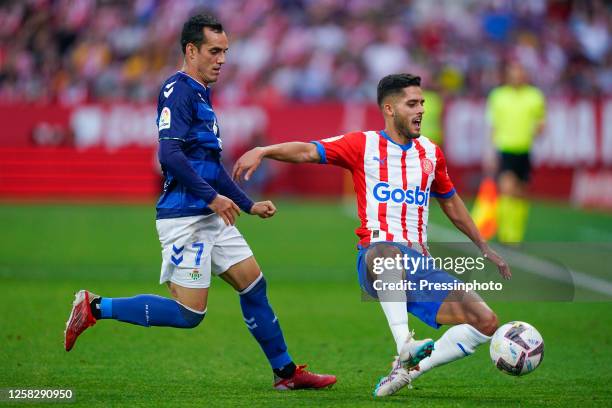 Juan Miguel Jimenez Juanmi of Real Betis and Yan Couto of Girona FC during the La Liga match between Girona FC and Real Betis played at Montilivi...