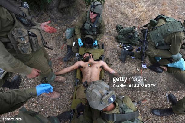 Israeli soldiers take part in the annual general military exercise 'Firm Hand' in the northern Kibbutz of Yiftah near the border with Lebanon on May...