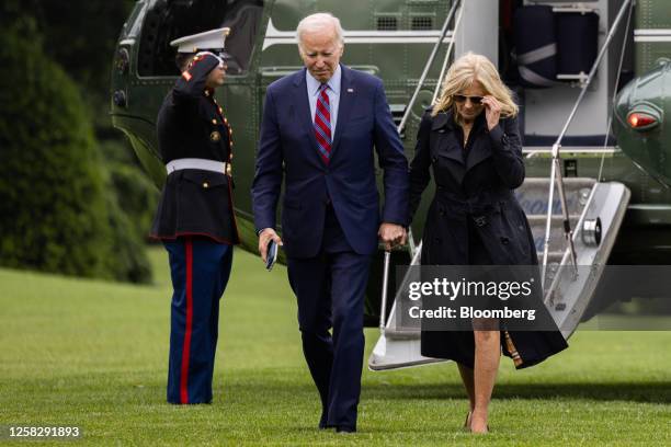 President Joe Biden and First Lady Jill Biden, right, walk on the South Lawn of the White House after arriving on Marine One in Washington, DC, US,...