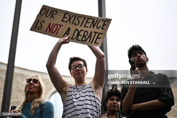 Pro-transgender activists hold placards during a gathering in Oxford, on May 30 to demonstrate against Britain's feminist, philosopher and writer...