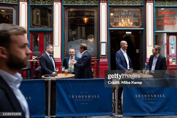 City workers enjoying a drink at Leadenhall Market in the City of London on 25th May 2023 in London, United Kingdom. Located in Gracechurch Street,...
