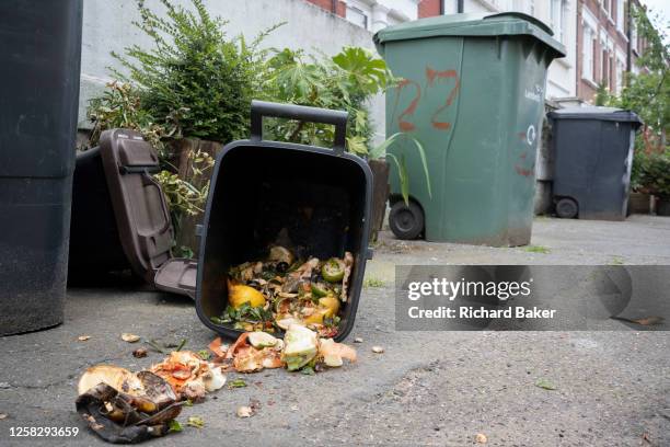Bin containing food waste has been opened and its contents spilled across the pavement in Camberwell, south London, on 30th May 2023, in London,...