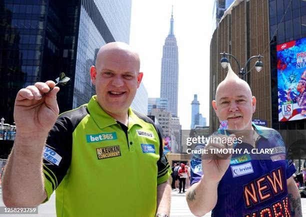 Dutch professional darts player Michael "Mighty Mike" van Gerwen and Scottish professional darts player Peter "Snakebite" Wright stand for a photo...