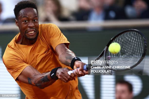 France's Gael Monfils plays a backhand return to Argentina's Sebastian Baez during their men's singles match on day three of the Roland-Garros Open...