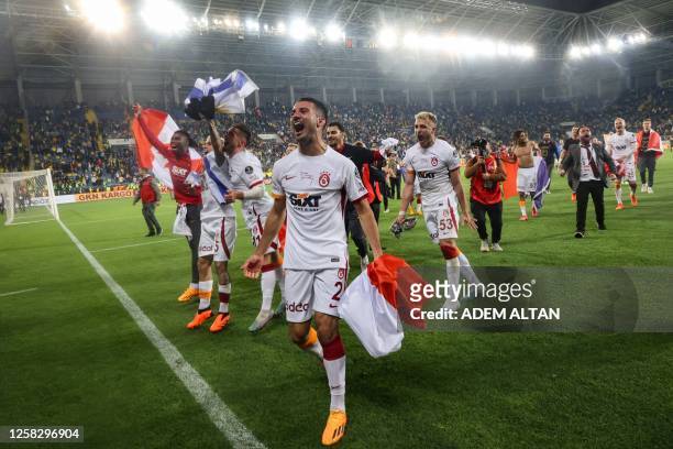 Galatasaray's French defender Leo Dubois celebrates with teammates after winning the team's 23rd title following Turkey's Super Lig football match...
