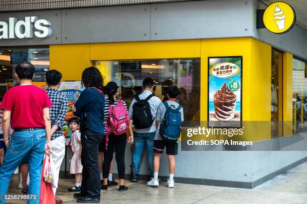 People line up at a McDonald's in Quarry Bay to purchase frozen treats as an amber alert for extreme heat is issued. The Hong Kong Observatory...