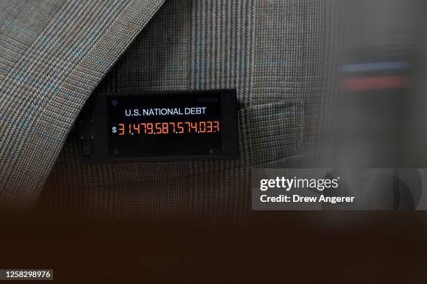 Rep. Thomas Massie wears a pin showing the U.S. National debt during a meeting of the House Rules Committee to consider H.R. 3746 - Fiscal...