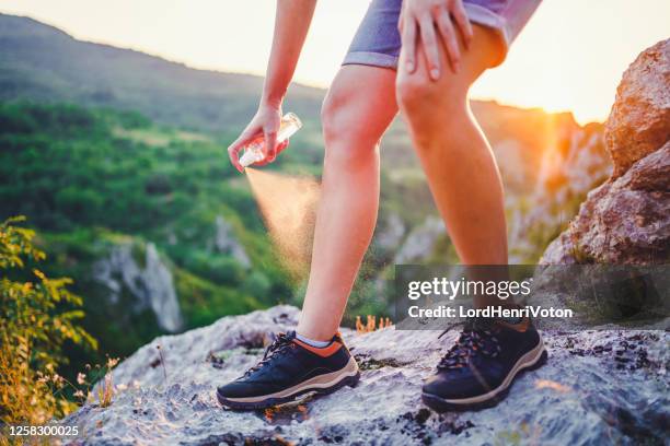 woman using anti mosquito spray outdoors at hiking trip - insect bites images stock pictures, royalty-free photos & images