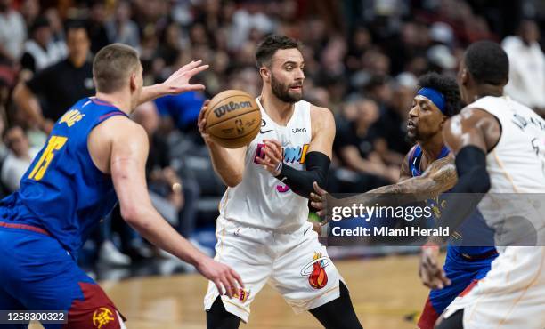 In this photo from Feb. 13 Miami Heat guard Max Strus looks to pass as Denver Nuggets center Nikola Jokic and guard Kentavious Caldwell-Pope defend...