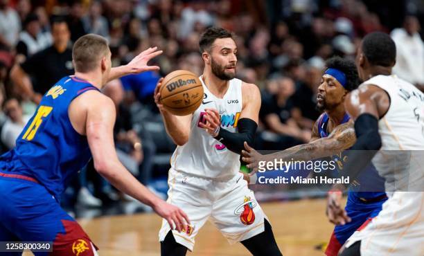Miami Heat guard Max Strus looks to pass as Denver Nuggets center Nikola Joki? and guard Kentavious Caldwell-Pope defend during the third quarter of...