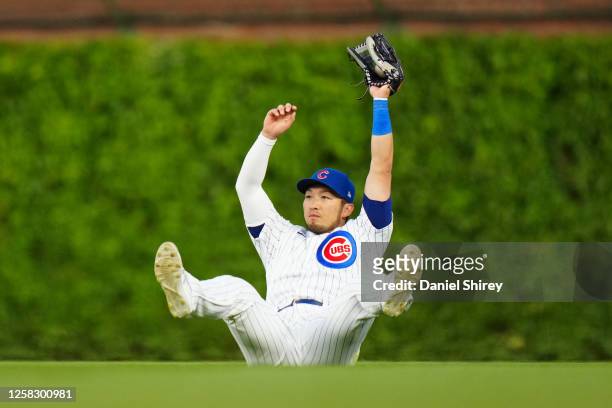 Seiya Suzuki of the Chicago Cubs makes a diving catch during the fourth inning of the game between the Tampa Bay Rays and the Chicago Cubs at Wrigley...