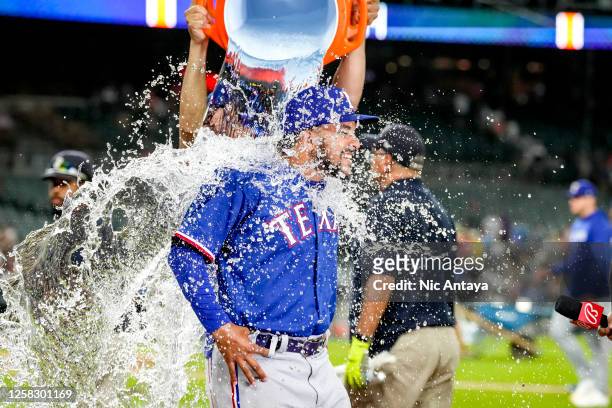Water is dumped on Grant Anderson of the Texas Rangers while he is interviewed after the win against the Detroit Tigers at Comerica Park on May 30,...