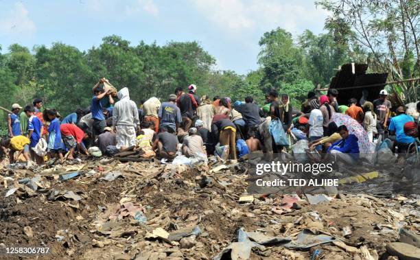 Residents gather scrap metals dump by a bus company on the outskirts of Central Philippines' city of Bacolod on February 9, 2011. Poverty worsened in...