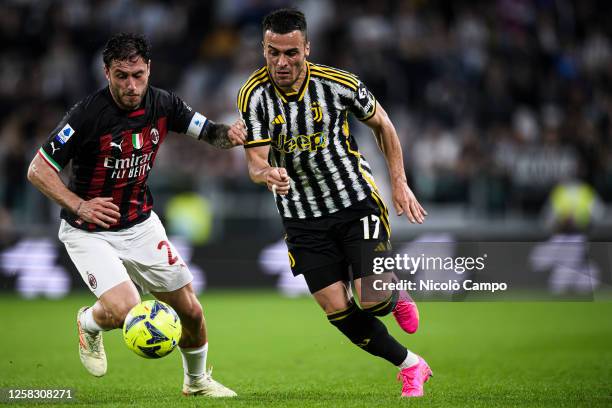 Filip Kostic of Juventus FC competes for the ball with Davide Calabria of AC Milan during the Serie A football match between Juventus FC and AC...