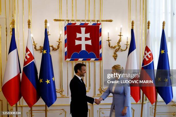 French President Emmanuel Macron and Slovakian President Zuzana Caputova shake hands at the Presidential Palace in Bratislava, Slovakia, on May 31,...