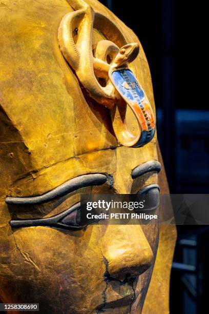 At the exhibition "Ramses and the Gold of the Pharaohs" at the Grande Halle de La Villette, here, Gold plated wooden mask, bronze, carnelian and...