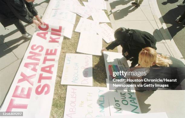 People place protest signs on the lawn in front of the state Capitol in Austin during a rally to abolish Texas' death penalty and plead for the life...