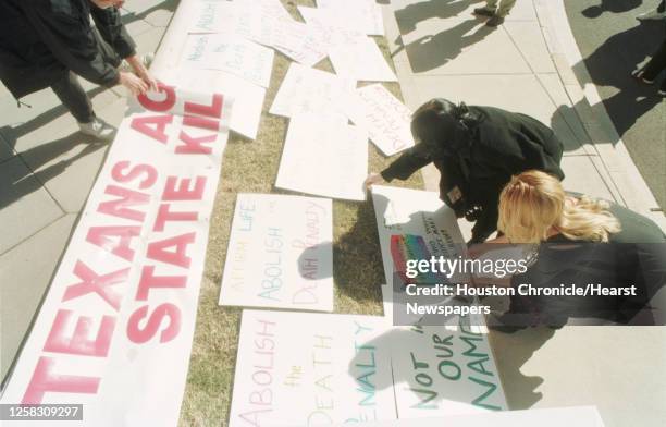 People place protest signs on the lawn in front of the state Capitol in Austin during a rally to abolish Texas' death penalty and plead for the life...