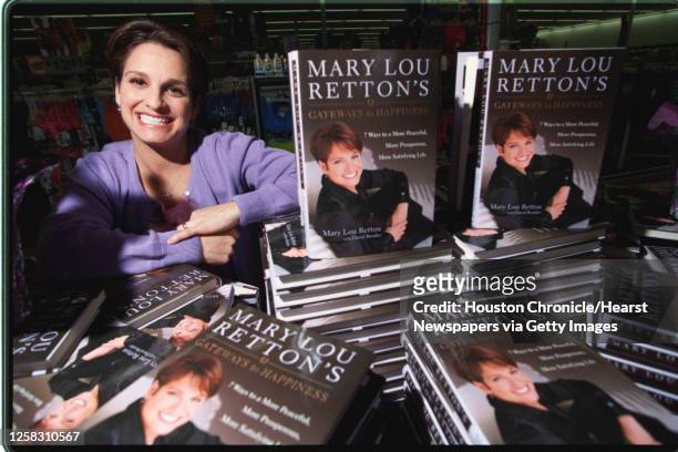 Mary Lou Retton stands next to a stack of her books in a Webster area Walmart, 4/20/00, during a book signing tour for her new book, 'Gateways to...