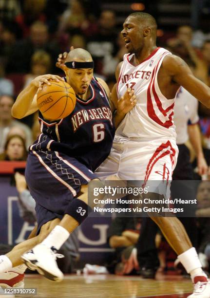 Kelvin Cato tries to slow down the attack of the Net's, Kenyon Martin, in the second half during the Houston Rockets-New Jersey Nets NBA basketball...