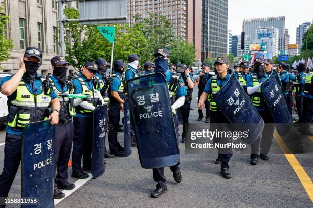 Police surround the protesters during a protest of the government's labor policies on May 31, 2023 in Seoul, South Korea. The Korean Confederation of...