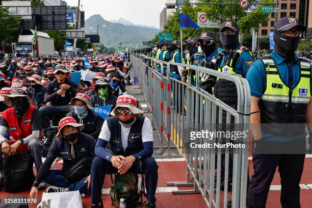Police surround the protesters during a protest of the government's labor policies on May 31, 2023 in Seoul, South Korea. The Korean Confederation of...