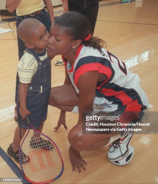 Sheryl Swoopes' 2-year-old son, Jordan Jackson, gives his mom a kiss during media day, just before the start of the 2000 season. HOUCHRON CAPTION :...