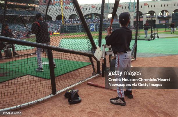 Barry Bonds of the San Francisco Giants takes batting practice as his son Nikolai watches and imitates before the Giants take on the Houston Astros...