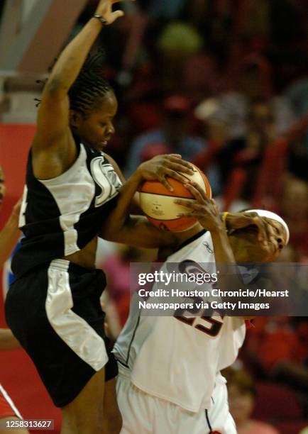 San Antonio's, Shannon Johnson jumps up over Houston's, Dominique Canty for the loose ball, during the second half of the season opener WNBA game...