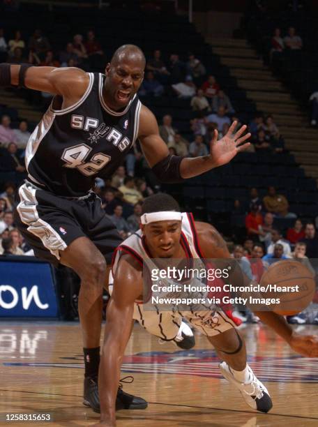 Houston's, Eddie Griffin gets tripped up by San Antonio's, Kevin Willis in the 3rd quarter action, during the Houston Rockets-San Antonio Spurs...