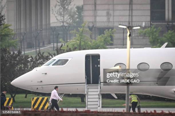 Tesla Chief Executive Officer Elon Musk boards his private jet before departing from Beijing Capital International Airport on May 31, 2023. Musk...