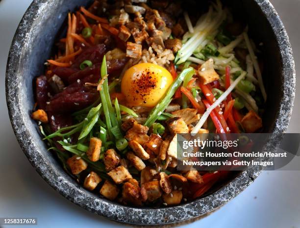 The Volcano Rice dish: with pork, Chinese sausage, chicken, special rice, carrots, zucchini, red bell peppers, snow peas, green onions, white sesame...