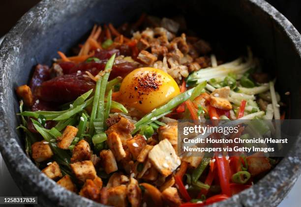 The Volcano Rice dish: with pork, Chinese sausage, chicken, special rice, carrots, zucchini, red bell peppers, snow peas, green onions, white sesame...