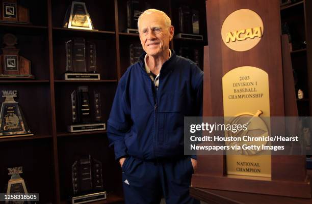 Rice coach Wayne Graham stands in the Rice baseball offices surrounded by a shelves full of trophies including the 2003 College World Series trophy,...