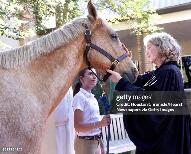 Reverend Diane McGehee blesses "Tiki" the horse as Lauren Novick holds him during the Blessing of the Animals at Bellaire United Methodist Church on...