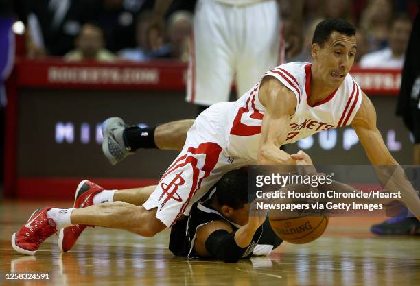 Houston Rockets guard Pablo Prigioni and Sacramento Kings guard Ray McCallum chase a loose ball during the second half of an NBA game at Toyota...