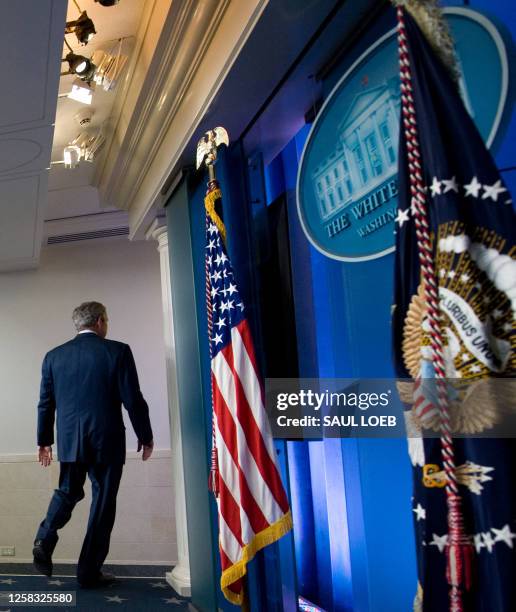 President George W. Bush leaves after holding his final press conference in the Brady Press Briefing Room at the White House in Washington, DC, on...