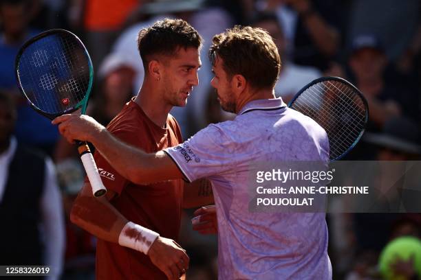 Australia's Thanasi Kokkinakis comforts Switzerland's Stan Wawrinka after his victory during their men's singles match on day four of the...