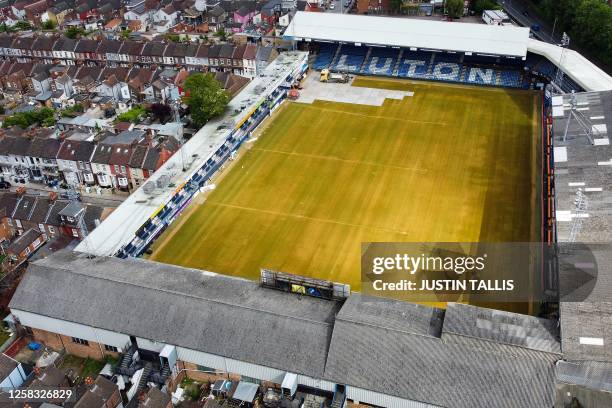 An aerial picture taken on May 31, 2023 shows Luton Town's Kenilworth Road stadium, in Luton, as members of the ground staff remove the pitch lines...