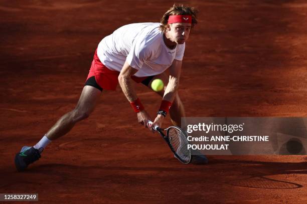 Russia's Andrey Rublev plays a backhand return to France's Corentin Moutet during their men's singles match on day four of the Roland-Garros Open...