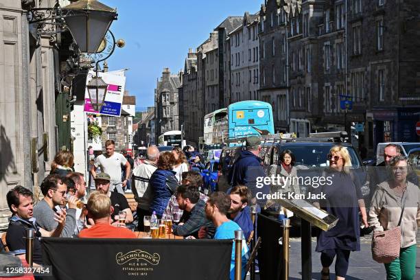 May 31: People enjoy the sunshine on the Royal Mile, on May 31, 2023 in Edinburgh, Scotland.